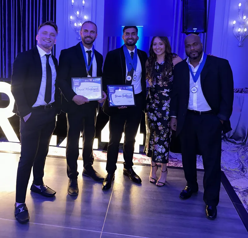Team members receiving awards and certificates at a company ceremony